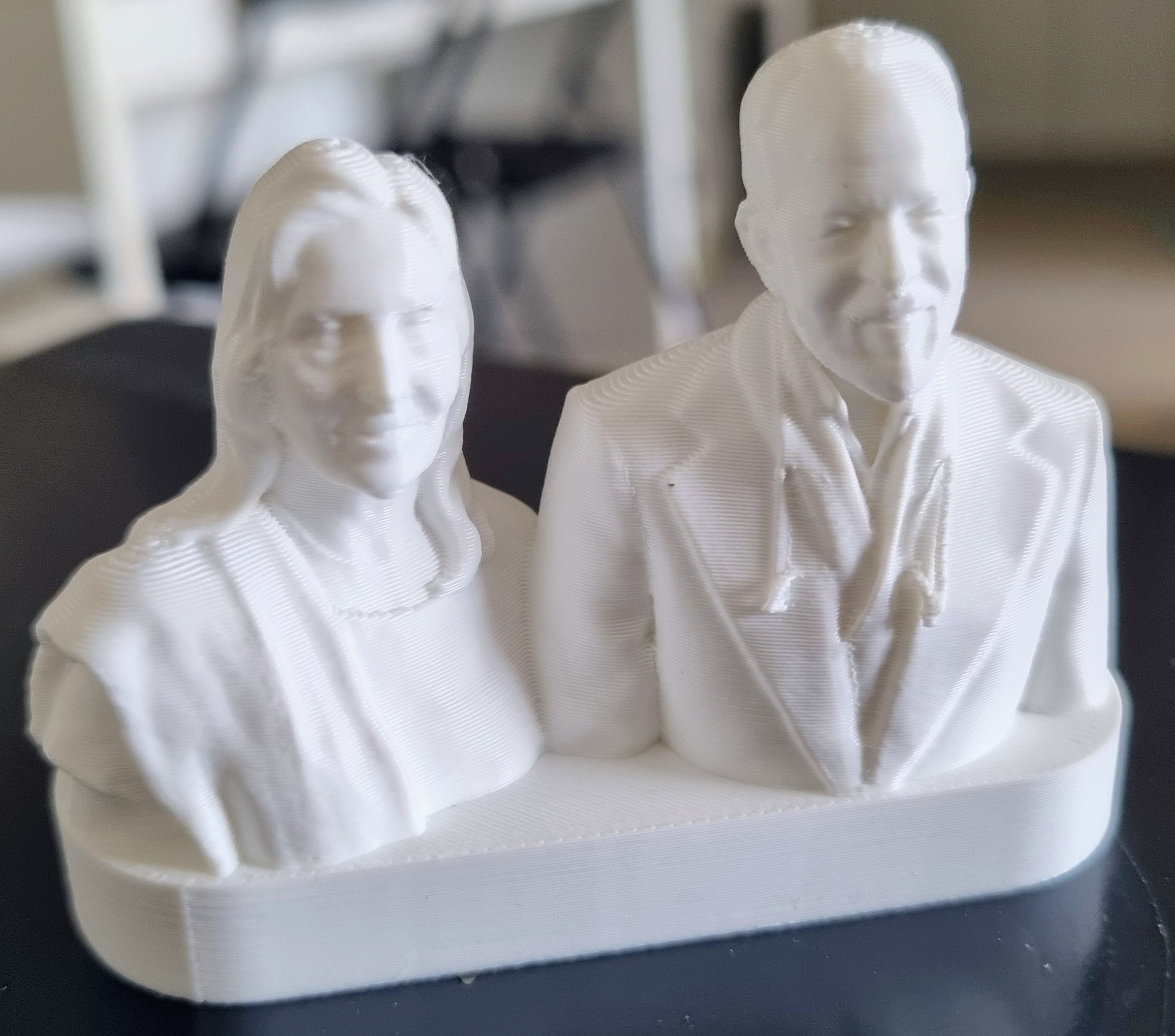 A white 3D printed bust of a woman and a man together, made for fifty years of companionship