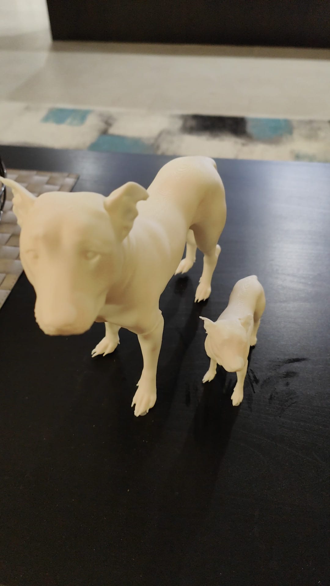 A cream 3D printed figure of a dog standing beside a smaller dog, made as a keepsake of Pandy
