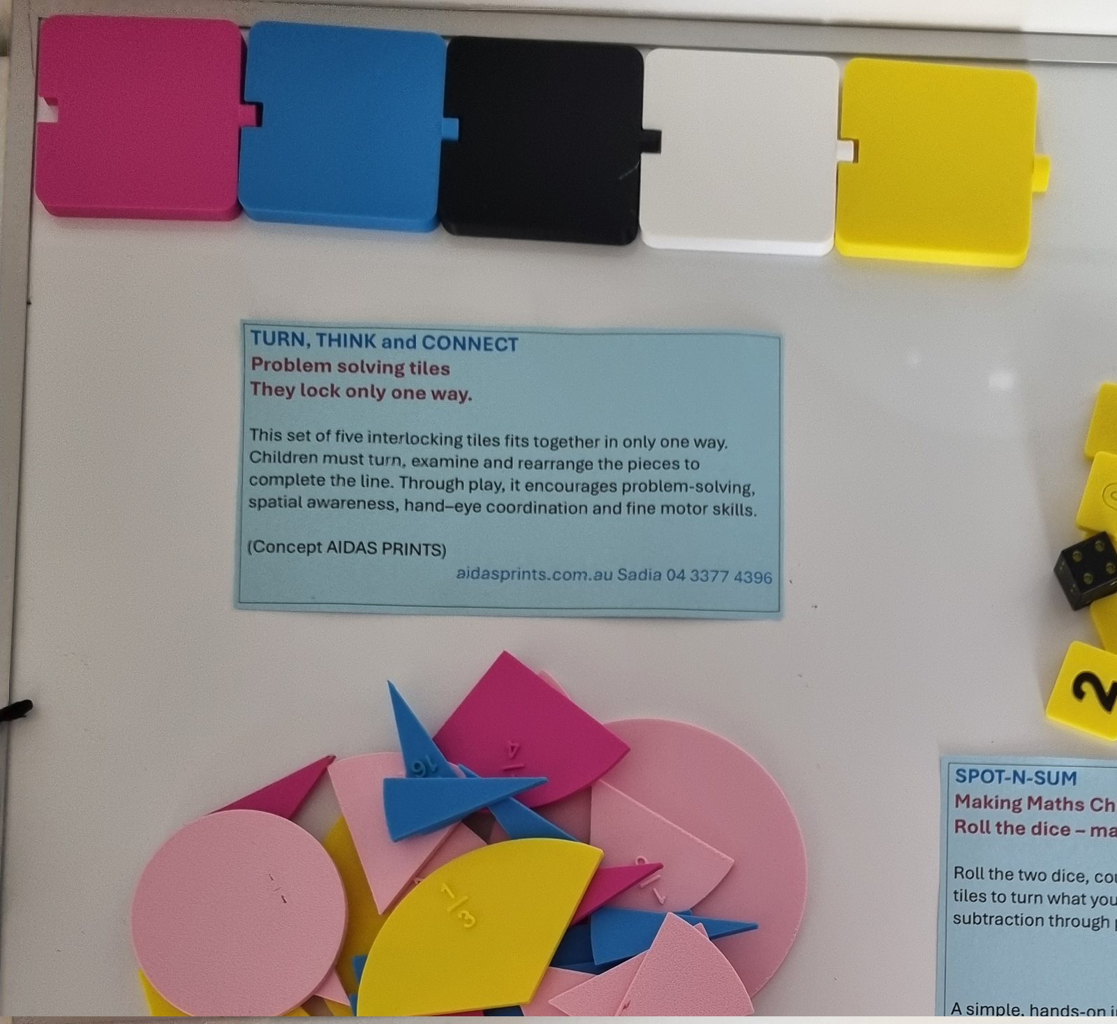 Five interlocking tiles in pink, blue, black, white and yellow, beside a Turn, Think and Connect card
